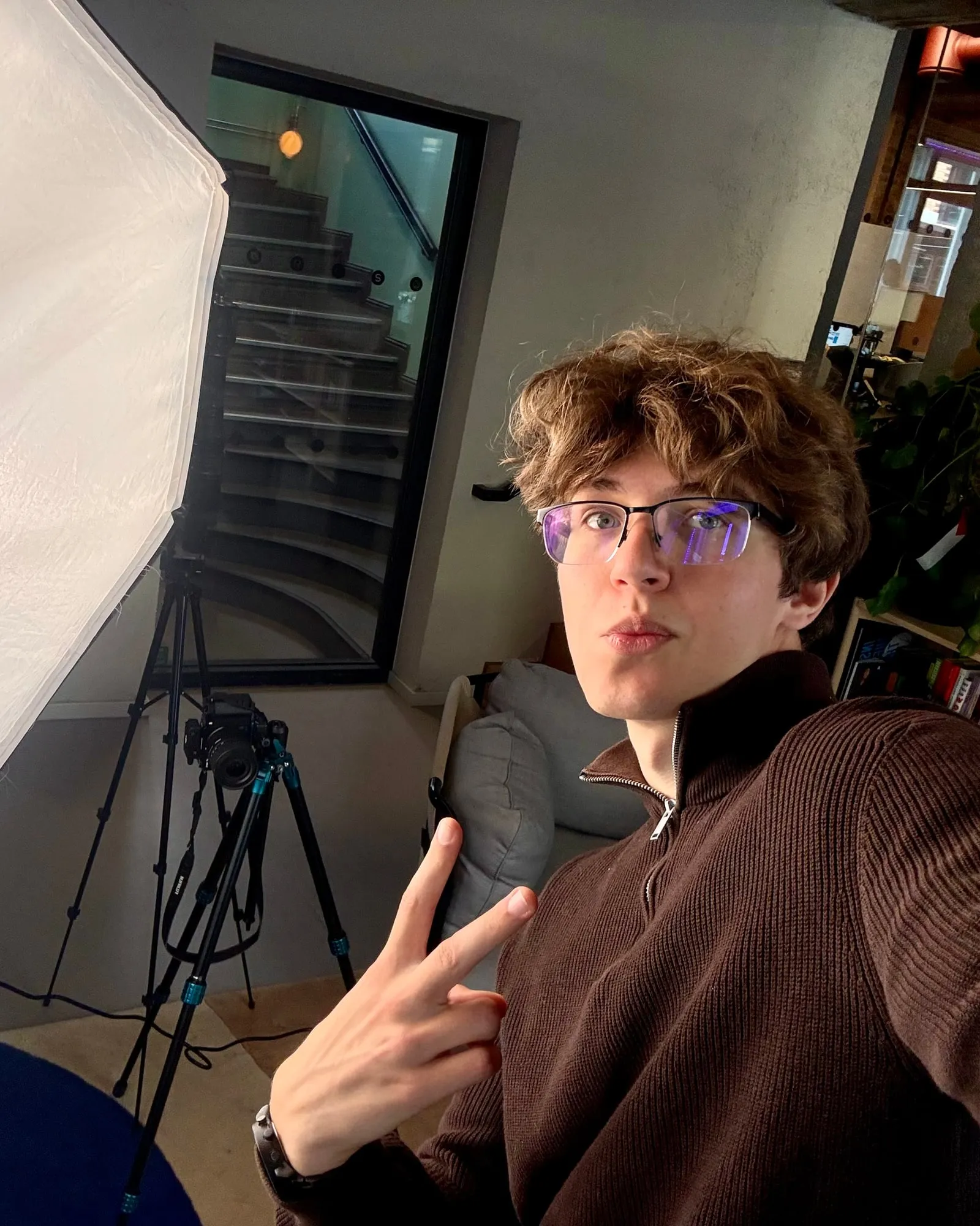Vladyslav Yarovyi in a studio, next to a softbox light and a camera on a tripod