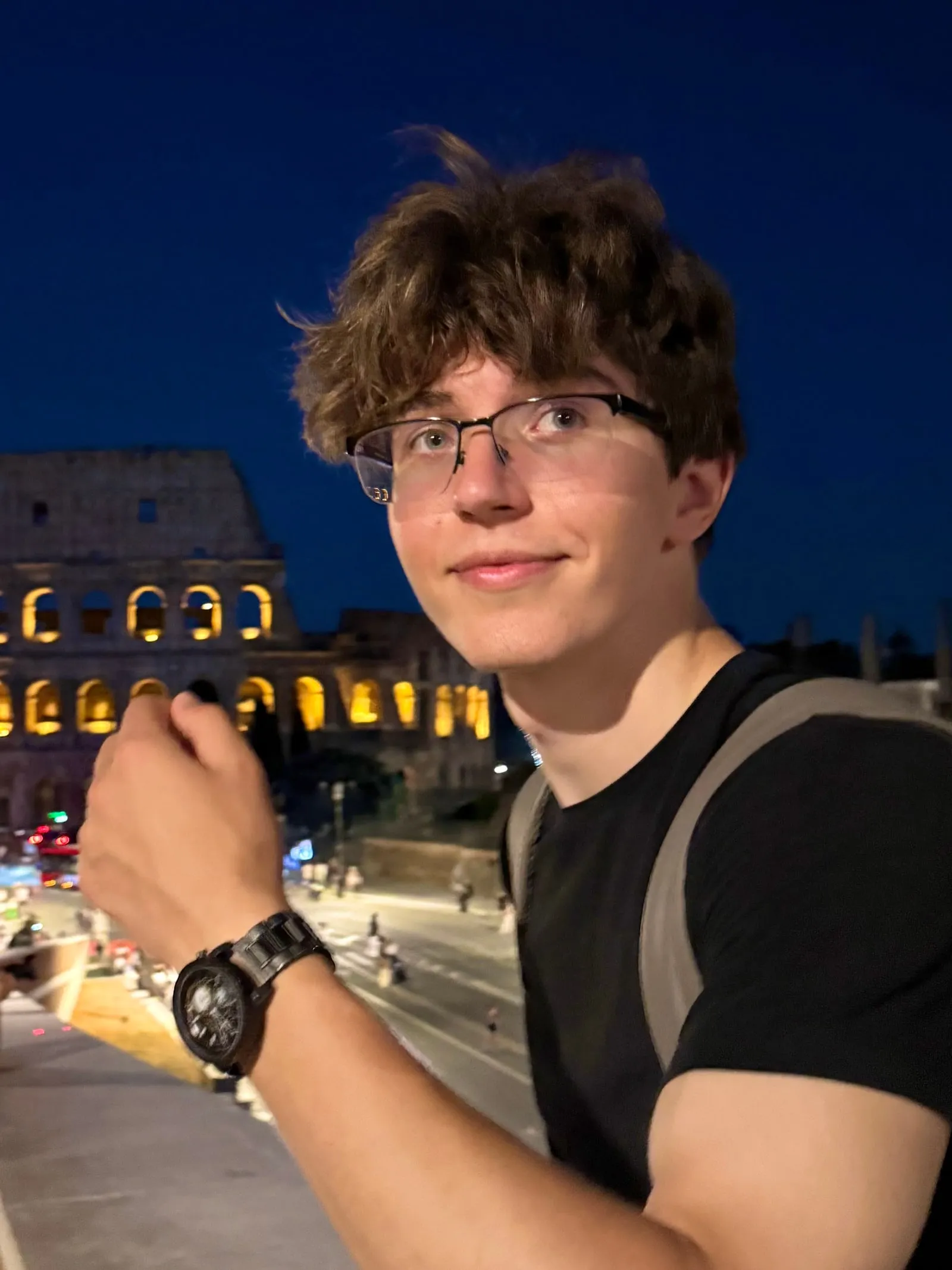 Vladyslav Yarovyi at night in Rome, with the Colosseum behind him